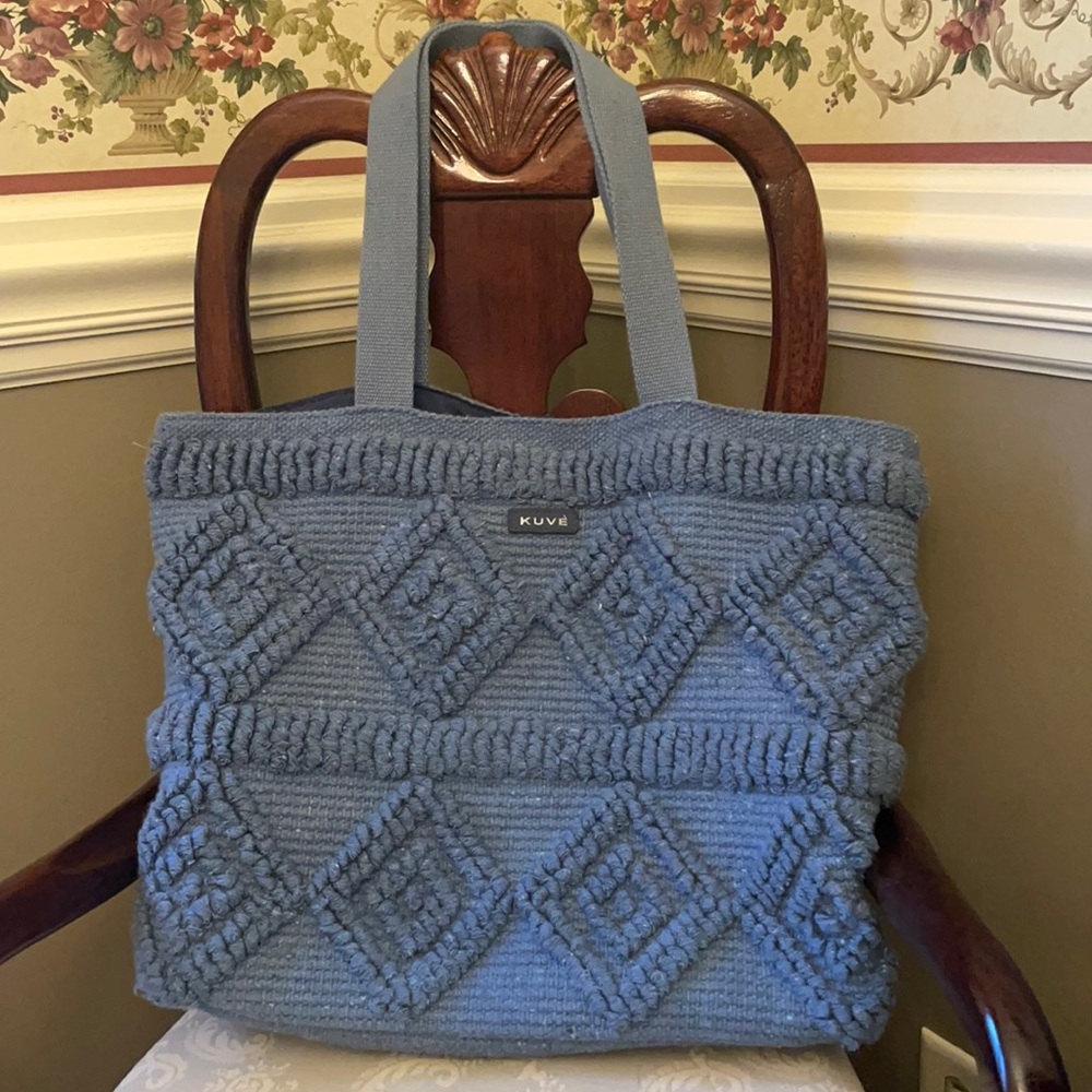 Woven cotton Kuve dusty blue tote bag with 10” straps, interior pockets, snaps